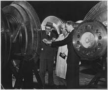 Belgian electrical engineers inspecting the rotor of a 40,000 kilowatt turbine of the General Electric Company in New York City Belgium. Belgian electrical engineers Georges Jean L. Van Antro, left, Georges H. Marchal, center, and Jacques de... - NARA - 541661.tif