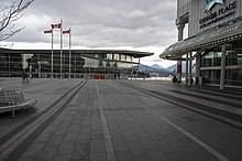 Deserted exterior of Canada Place. Note the two pedestrians on the left wearing face masks. Canada Place during COVID-19.jpg