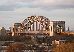 The main span, an arch bridge with stone towers at either end, as seen from Queens
