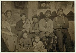 Manuel Sousa and family, 306-2(nd) St., On right end is brother-in-law; next (to) him is father who works on the river; next is Manuel (appears to be 12 years old) wearing sweater and has LOC cph.3b12096.jpg