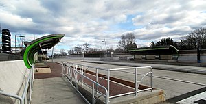 A bus station with two curved canopies