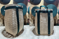 A three-quarters front view (left) and back view (right) of a modern pack basket manufactured by Pack Baskets of Maine. The basket is woven from maple strips and has green canvas straps to be carried on the back.