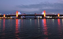 The Pearl Harbor Memorial Bridge, locally known as the Q Bridge, carries ten lanes over the Quinnipiac River along the Connecticut Turnpike. Q Bridge in New Haven Illuminated Red, White, and Blue (27460771747).jpg