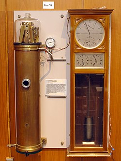 A Shortt-Synchronome free pendulum clock, the most accurate pendulum clock ever made, at the NIST museum, Gaithersburg, MD, USA. It kept time with two synchronized pendulums. The master pendulum in the vacuum tank (left) swung free of virtually any disturbance, and controlled the slave pendulum in the clock case (right) which performed the impulsing and timekeeping tasks. Its accuracy was about a second per year. Shortt Synchronome free pendulum clock.jpg