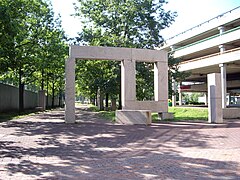 A sculpture of large granite blocks with pavers and trees