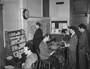 Journalists in the Radio-Canada/CBC newsroom i...