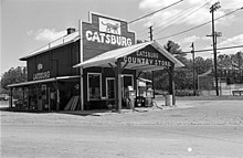 black and white photograph of a hip roof country store in 1987