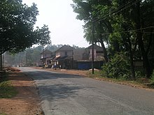 Road with utility wires and two-storey buildings