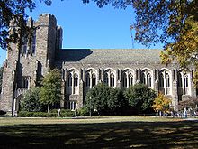 A building's Gothic-style exterior and grass lawn in foreground