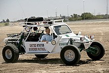 Former US President George W. Bush riding in a U.S. Border Patrol sand rail in Yuma, Arizona, in 2006. Presdunebuggy.jpg