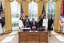 Kardashian (second from right) welcomes sentence commutation recipients with President Donald J. Trump, 2018 President Trump Meets with Sentencing Commutation Recipients (49624188912).jpg