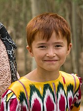 Uyghur girl in clothing made of fabric with design distinctive to the Uyghurs Uyghur-redhead.jpg