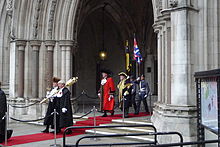 The Swordbearer and Macebearer walk ahead of the Lord Mayor, who is escorted by his ward beadle 2011 Lord Mayor emerging from Royal Courts of Justice 2011.jpg