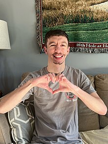 An adult with Williams syndrome making Heart Hands