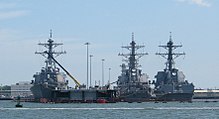 USS Cole (left) and two other Arleigh Burke-class destroyers docked at Naval Station Norfolk in July 2009 ArleighBurkeClassShips.jpg