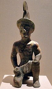 Possible statuette of a Greek hoplite, wearing a version of the Greek Phrygian helmet, from a 3rd-century BC burial site north of the Tian Shan, Xinjiang Region Museum, Urumqi. Bronze Warrior Statue without shade.jpg