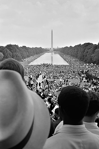 Crowds surrounding the Reflecting Pool, during...