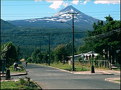 Street in Melipeuco and Llaima Volcano in the background.