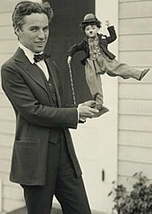 Charlie Chaplin, c. 1918 Charlie Chaplin with doll.jpg