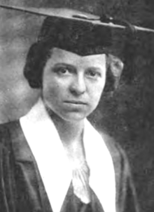A young white woman wearing an academic cap and gown