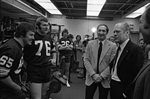 Black and white photo showing President Ford with Packers players during the Hall of Fame dedication ceremony