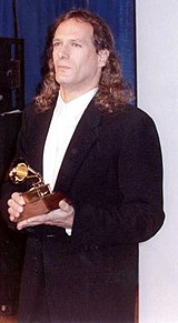 Michael Bolton holding his Grammy award in 1990.