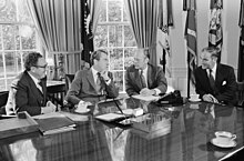 President Richard Nixon seated at his Oval Office desk during a meeting with Henry Kissinger, Alexander Haig, and Gerald Ford.jpg