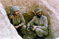 Ali Khamenei (right), who would become the second Supreme Leader of Iran in August 1989, in a spider hole with another Iranian soldier during the Iran–Iraq War