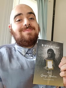 George Abraham with a copy of Birthright.