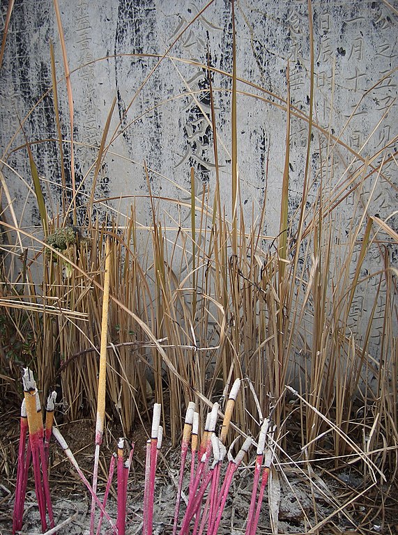 Incense is burned at the graves of ancestors as part of the offering and prayer ritual. (February 2005)