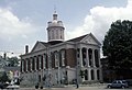 Red courthouse with white columns and a tall cupola