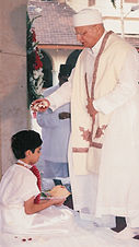 Parsi Navjote ceremony (rites of admission into the Zoroastrian faith). Parsi-navjote-sitting.jpg