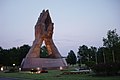 Dusk view of the Avenue of Flags and the bronze sculpture Praying Hands at the main entrance to Oral Roberts University in Tulsa, Oklahoma