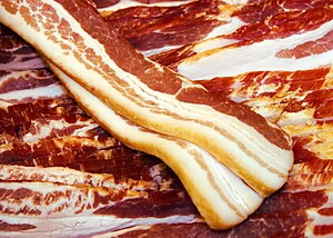 English: Uncooked pork belly bacon strips disp...