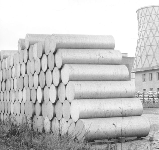 Extrusion billets of aluminum piled up before a factory