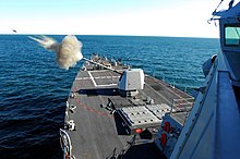 USS Forrest Sherman in 2007, test firing her new 5"/62-caliber Mark 45 Mod 4 gun, located forward of her 32-cell missile pack module US Navy 070111-N-4515N-509 Guided missile destroyer USS Forest Sherman (DDG 98) test fires its five-inch gun on the bow of the ship during training.jpg