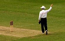 An umpire signals a decision to the scorers Cricket Umpire.jpg