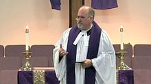 A Methodist minister delivering the sermon during a service of worship MethodistPastorvestedwithpreachingbands.jpg