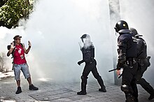 Police confront a demonstrator outside the Catalan Parliament on 15 June Parlamentcamp barcelona.jpg