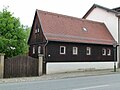 Wohnhaus mit verbrettertem Fachwerkobergeschoss