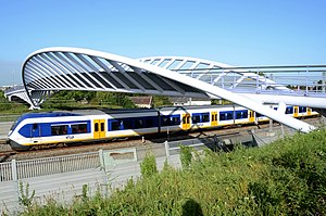 Foot/bicycle-bridge over the railway in Houten with Sprinter train of NS