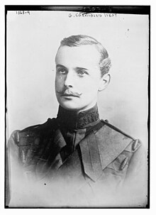 Old black-and-white photograph of a young white man from the chest up, wearing a dark military uniform and a thin handle-bar moustache