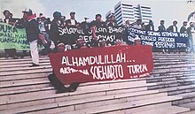 Students celebrating on the steps of the MPR Building, minutes after realizing that Suharto had resigned. Mahasiswa di DPR-MPR (cropped).jpg