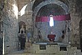 Interior de l'església de la Mare de Déu, amb el model d'església al timpà de la capella lateral