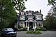 Front facade and circular driveway of large detached house