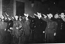 The establishment of Quisling's national government was proclaimed at Akershus Fortress. On the left side of the hall are Terboven (third from left) and several German officers, on the right Quisling (third from right) and several of his ministers Statsakten. Akershus. 1942-02-01. (8618019797).jpg