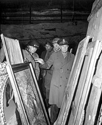 Dwight D. Eisenhower (right) inspects stolen artwork in a salt mine in Merkers, accompanied by Omar Bradley (left) and George S. Patton (center) Eisenhower, Bradley and Patton inspect looted art HD-SN-99-02758.JPEG