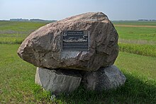 Simple rock cairn with bronze plaque