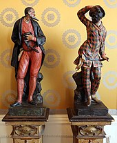 Statues of Pantalone and Harlequin, two stock characters from the commedia dell'arte, in the Museo Teatrale alla Scala Statue in legno e porcellana coi personaggi della commedia dell'arte, 01 pantalone e arlecchino.jpg