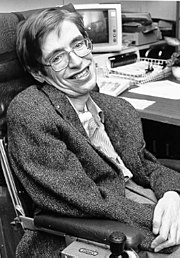 black and white photo of Hawking in a chair, in an office.
